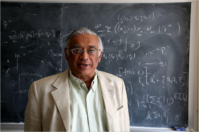 Profile picture of Srinivasa Varadhan standing in front of a blackboard