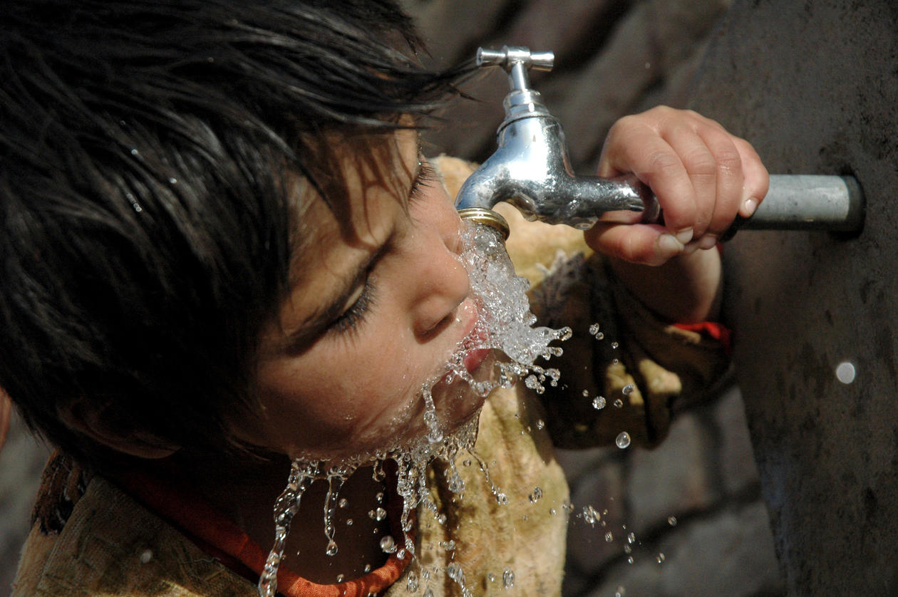 Child drinking from tap