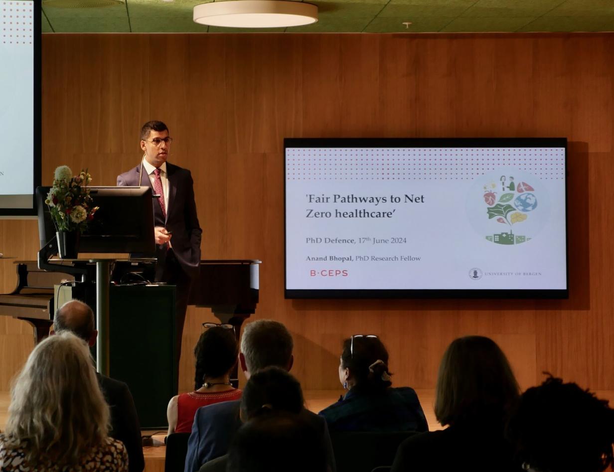 Anand Bhopal on stage, presenting his PhD dissertation research