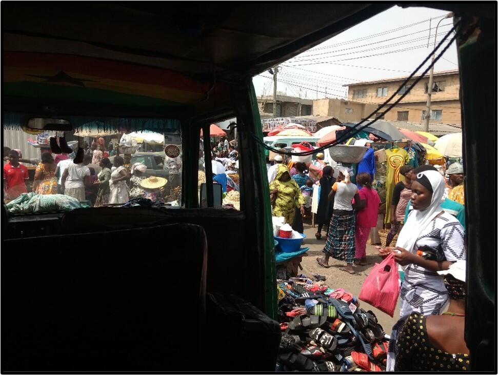 Picture taken from inside a bus of a bustling marketplace in Accra.
