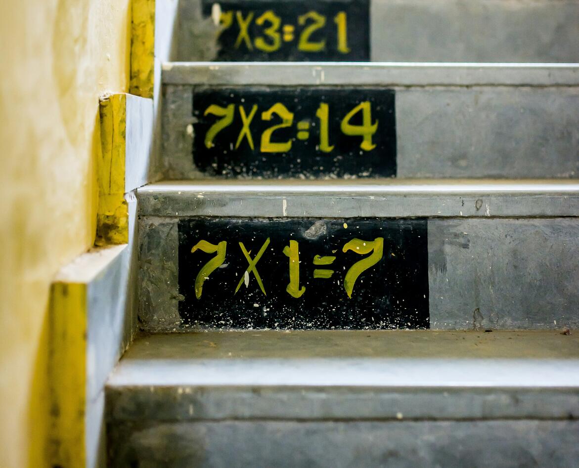 A staircase with the 7 times table painted on the steps