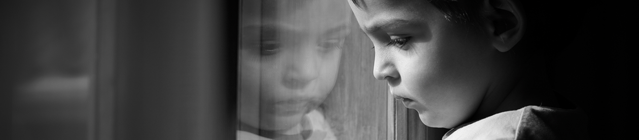 Child looking through window