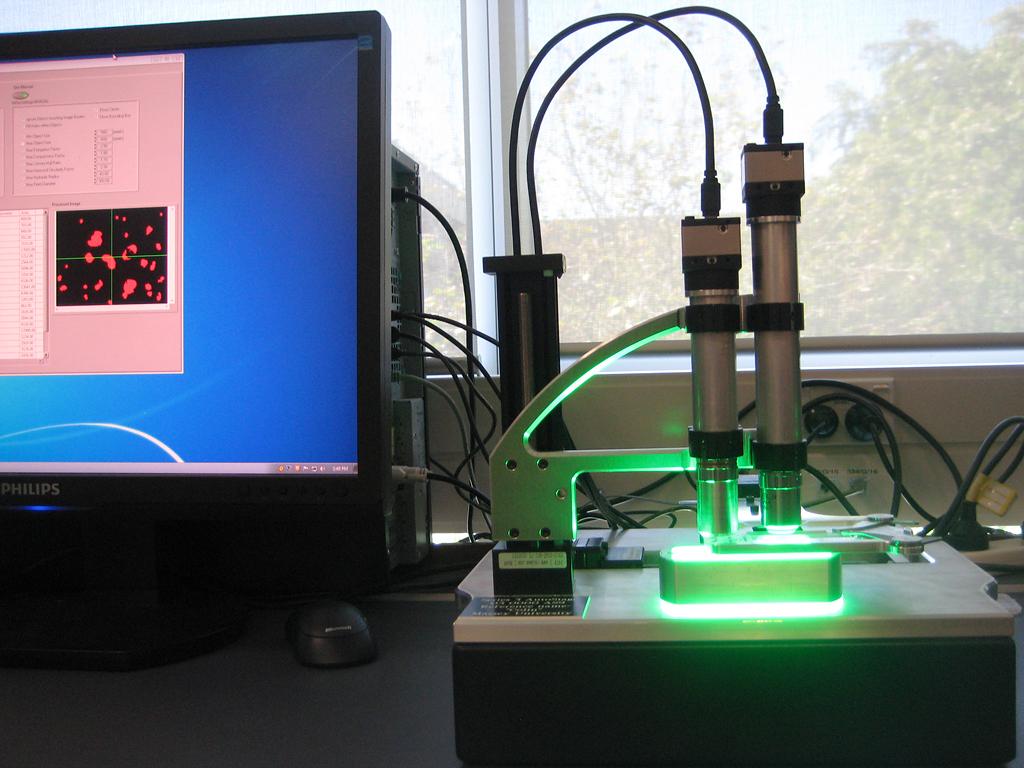 The automated pollen locator and counter, Classifynder, with part of a computer screen showing the output