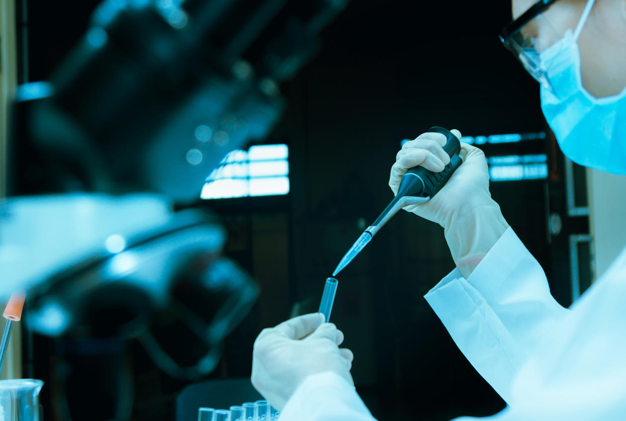 Scientist taking aliquote of an enzyme in modern lab,Young scientist works in modern biological lab,science concept,science people and selective focus, stock photo