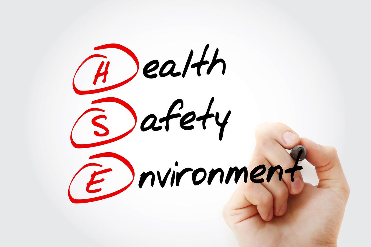 Illustration. A hand writing Health, Safety and environment