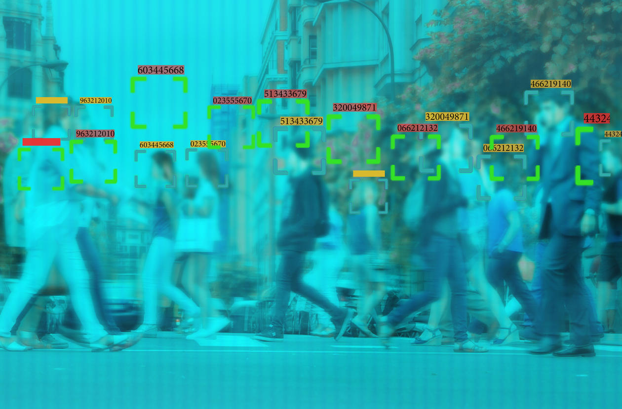 Blurry blue image showing a crowd of people with green boxes superimposed on the image, suggesting some kind of machine vision.