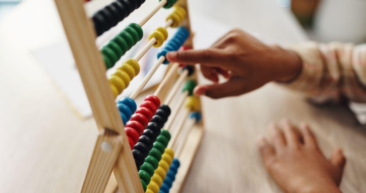 Hands counting on an abacus
