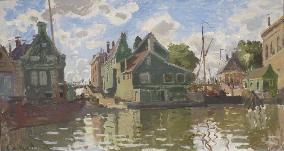 A painting of houses along a canal