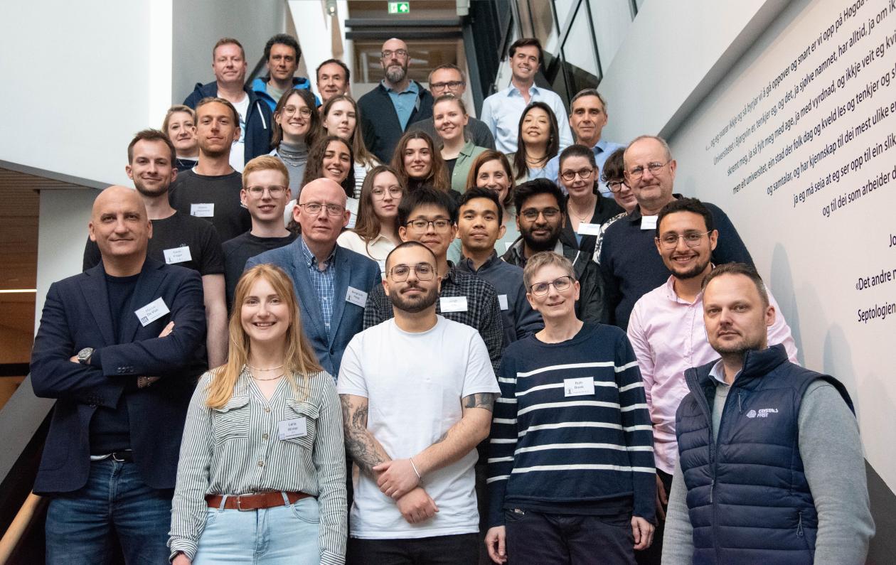 Group av people on the kick off meeting standing in the stairs