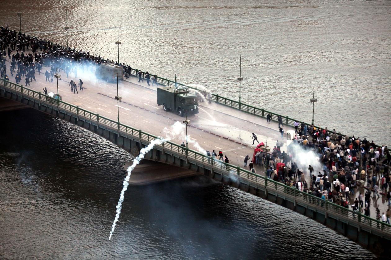 A picture of a confrontation between protestors and riot police on a bridge in Egypt during the Arab spring, which began in December 2010.