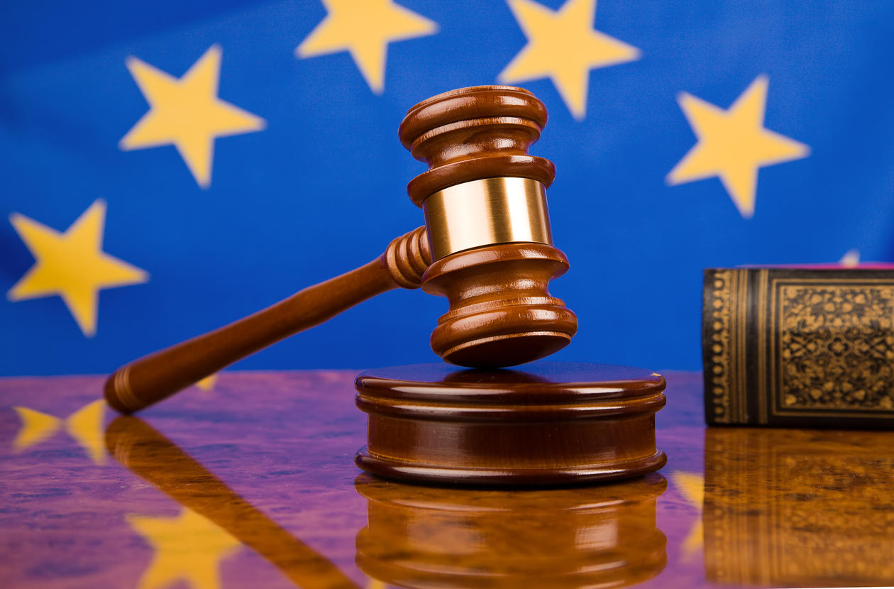 A gavel in court with an European flag in the background