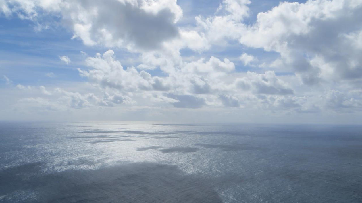 Image of the ocean with scattered clouds above. Used to illustrate article about UiB doing well in earth and marine sciences in QS by Subject rankings.