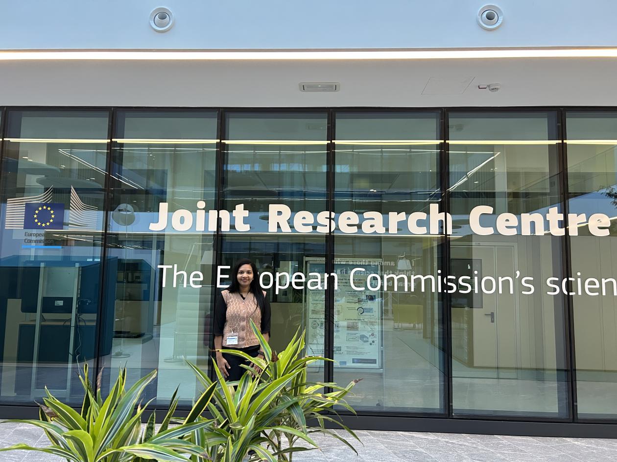 Young woman infront of glass building