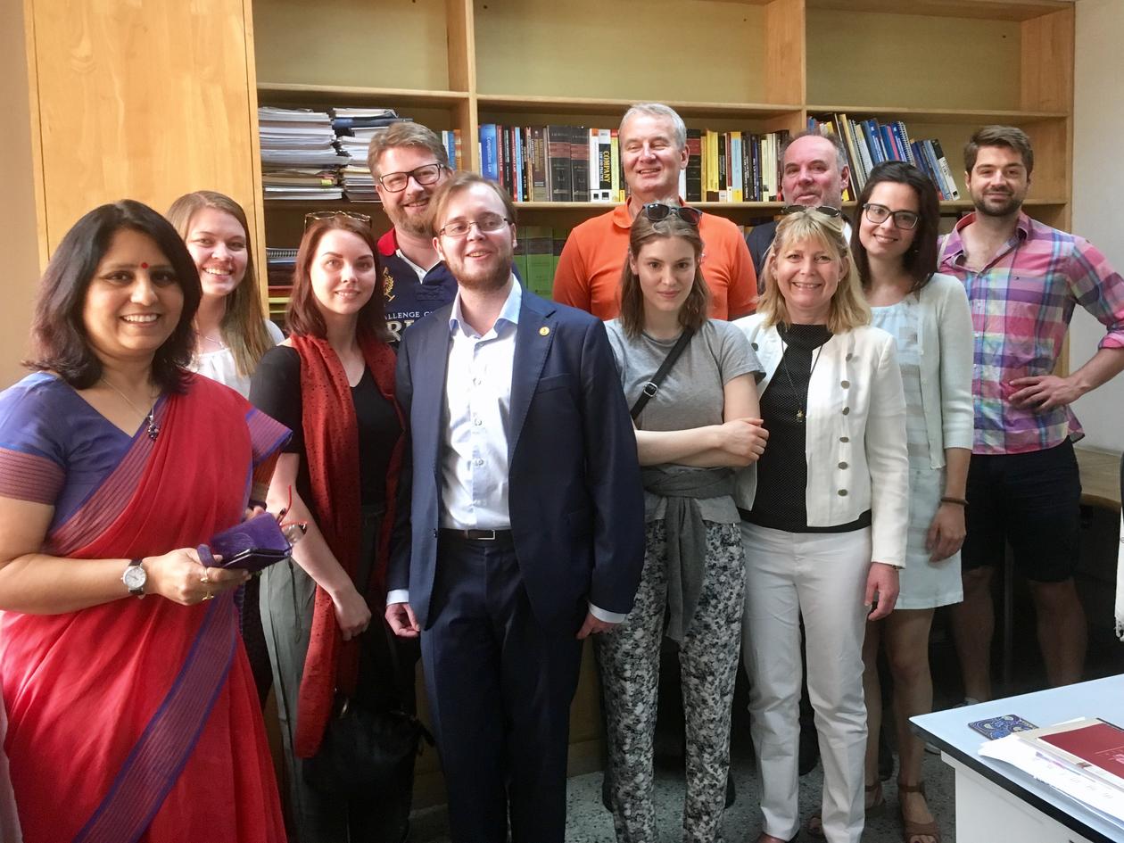Several people standing in an office