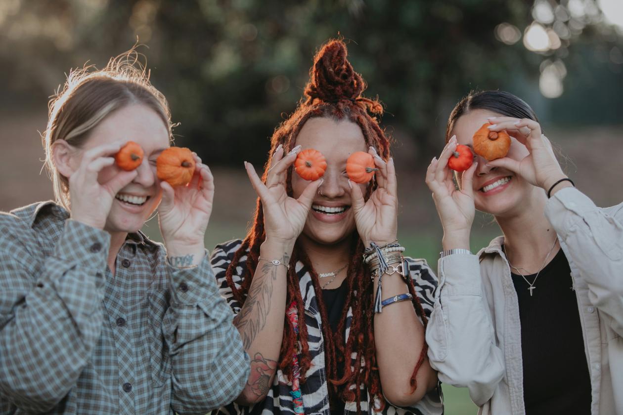 image of women holding pumpkins