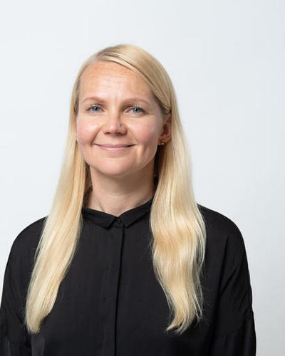 Portrait of a woman with long, blond hair and a black top