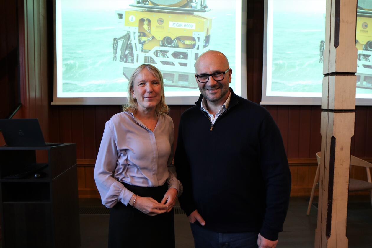 UiB-rektor Margareth Hagen og TV-produsent James Honeyborne foran bilde av UiBs undervansrobot Ægir