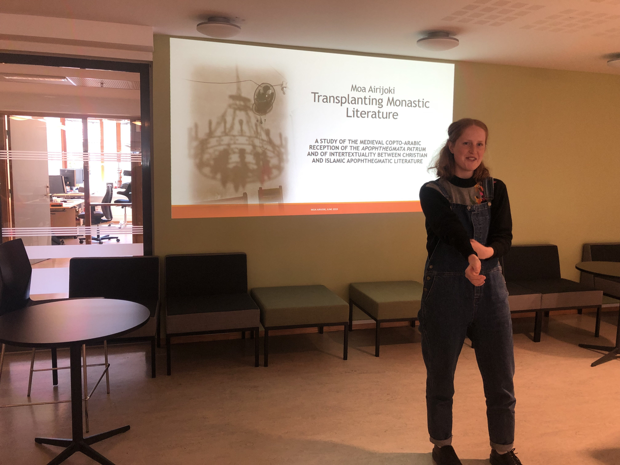 Moa Airijoki presents and the background shows the title page of her powerpoint "Transplanting Monastic Literature"