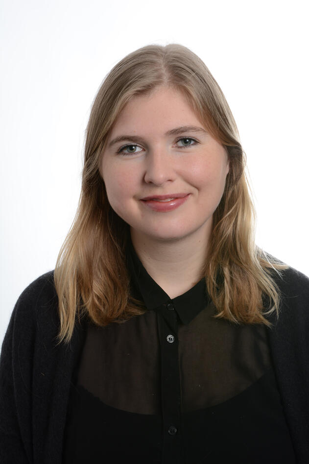 Portrait of young woman with blonde hair and black shirt. 