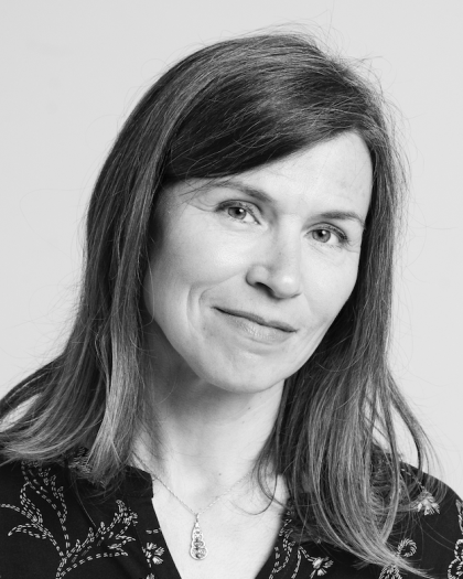 Black and white photo of a smiling young woman with long hair.