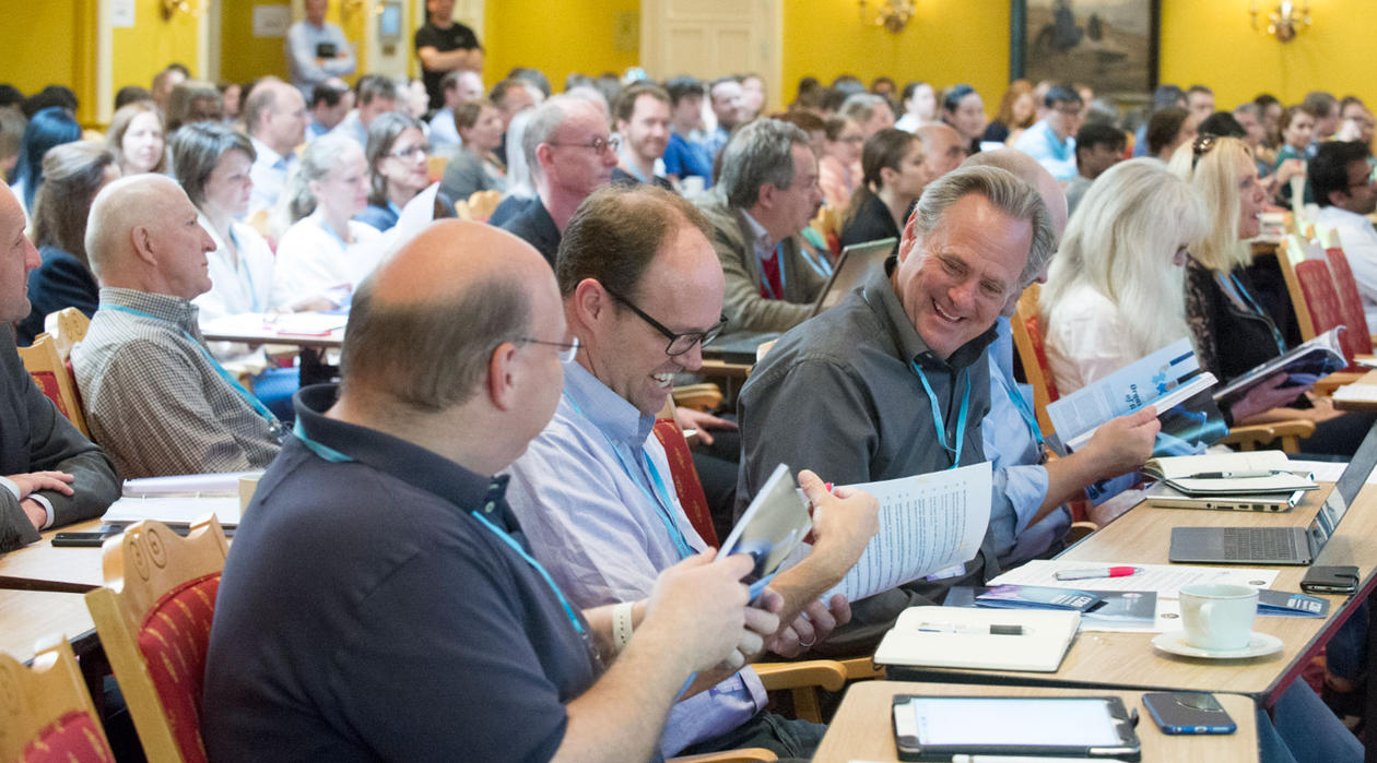 Photo from the audience at the CCBIO Annual Symposium 2016, clearly with a good atmosphere as people are smiling.