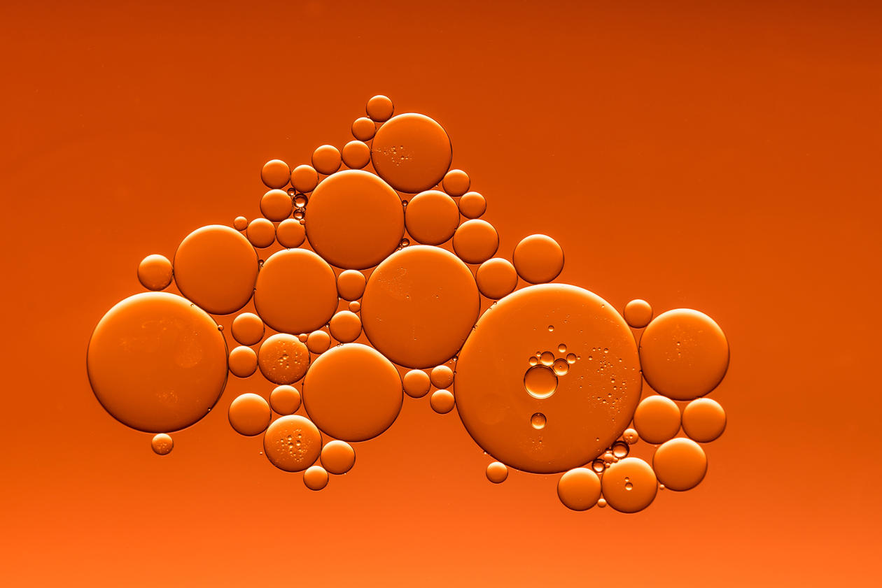 Oil dropped in water with an orange background colour.
