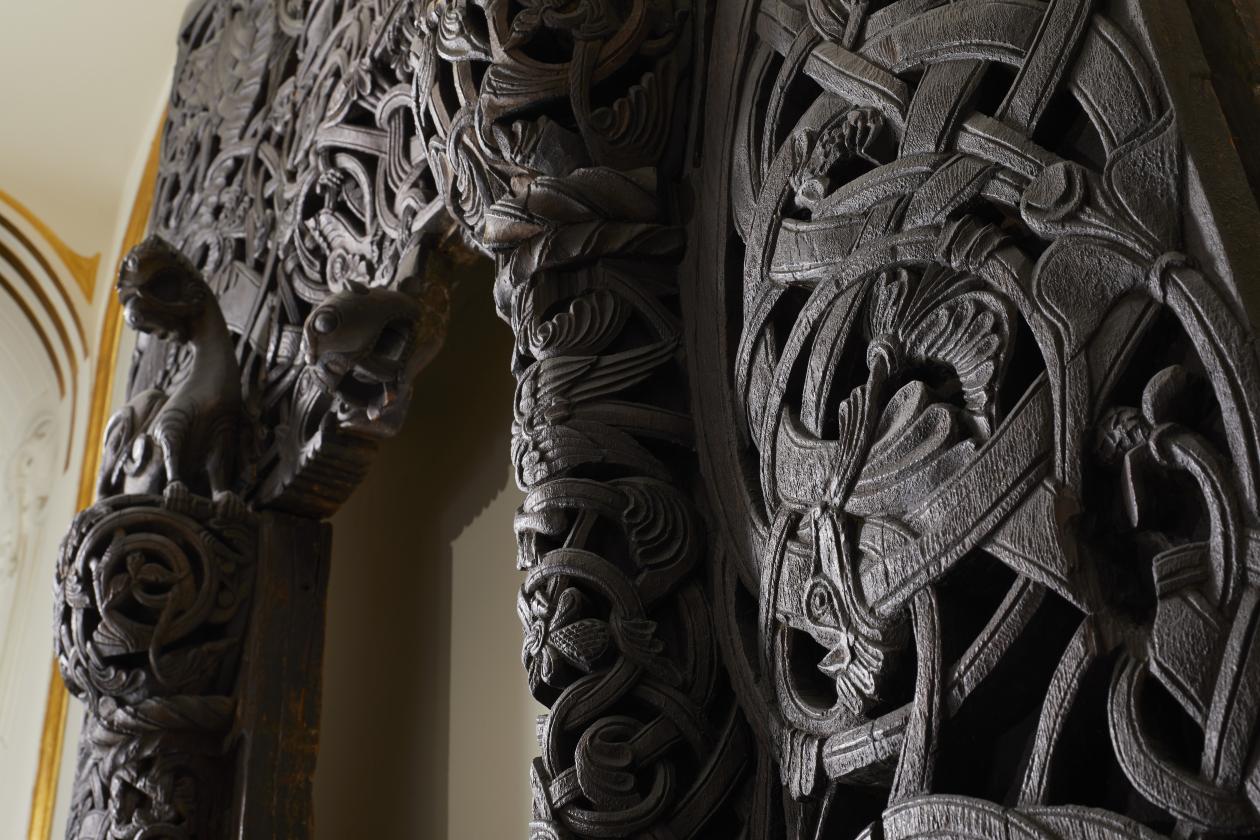 Bilde av en mørk stavkirkeportal 