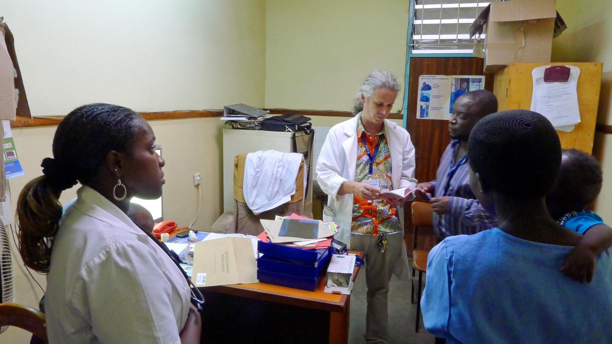 University of Bergen researcher and surgeon Sven Young consulting with assistants and the mother of an infant, who may have broken a bone, at Kamuzu Central Hospital in Lilongwe, Malawi.