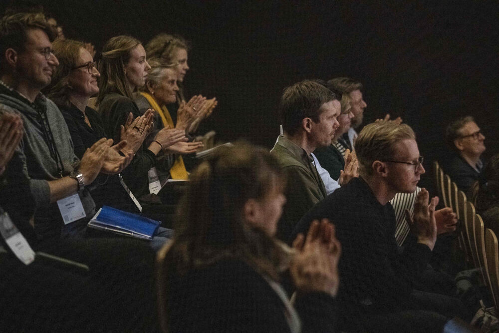 Audience clapping during keynote session