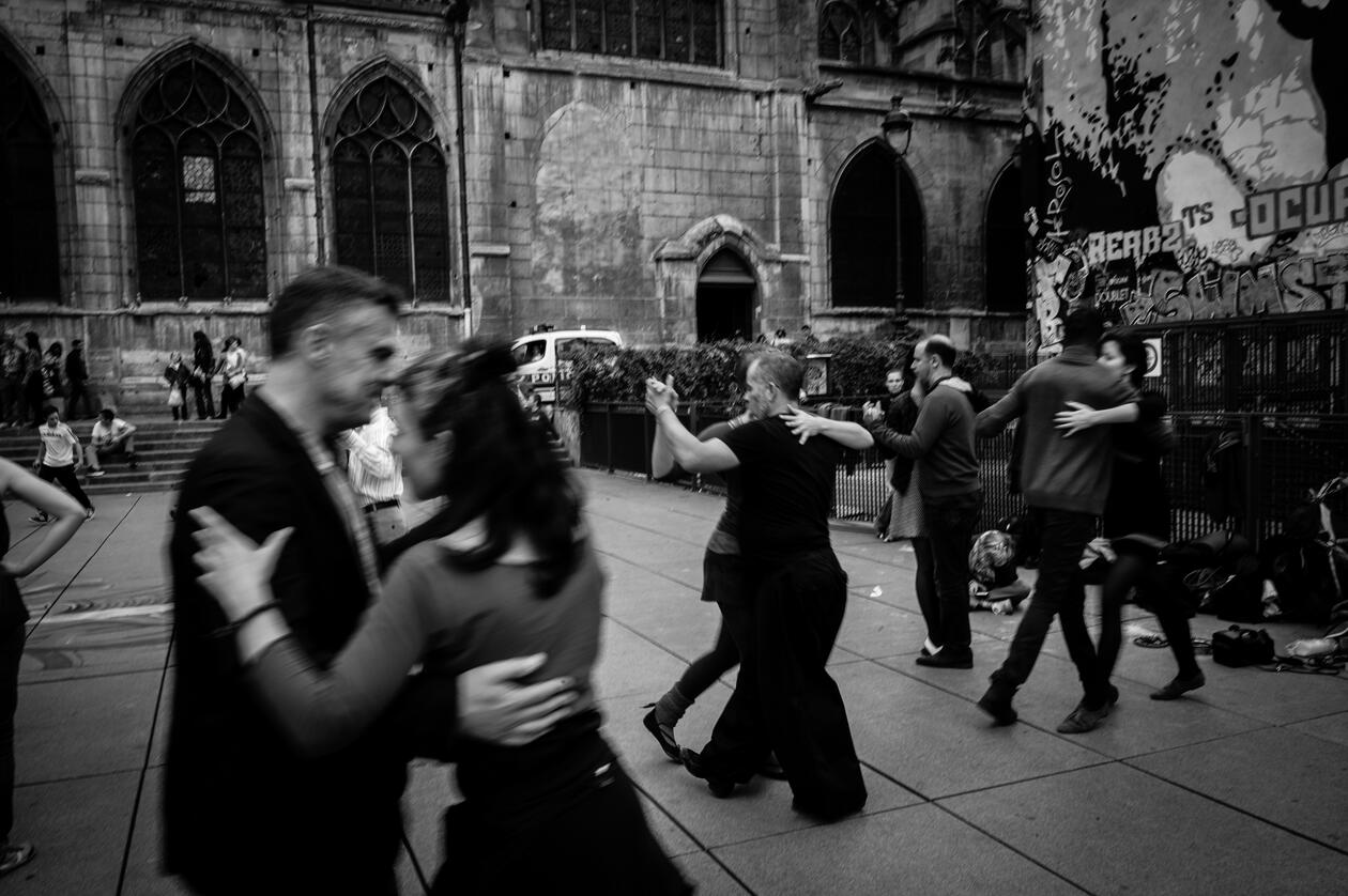 Black and white photo of several couples dancing tango
