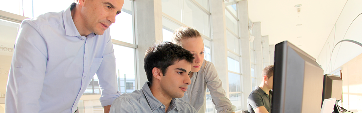 Three people looking at a computer screen