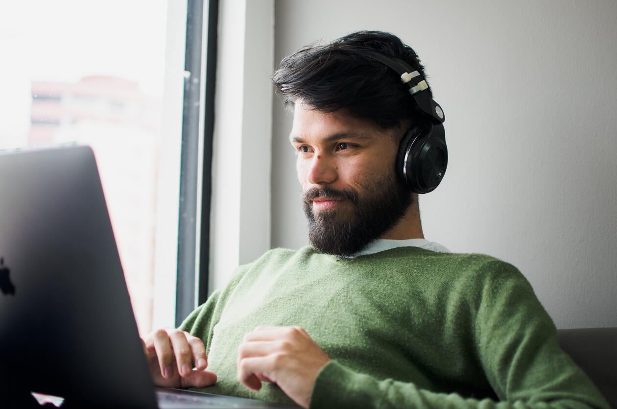 Man listening to music while workin at his computer