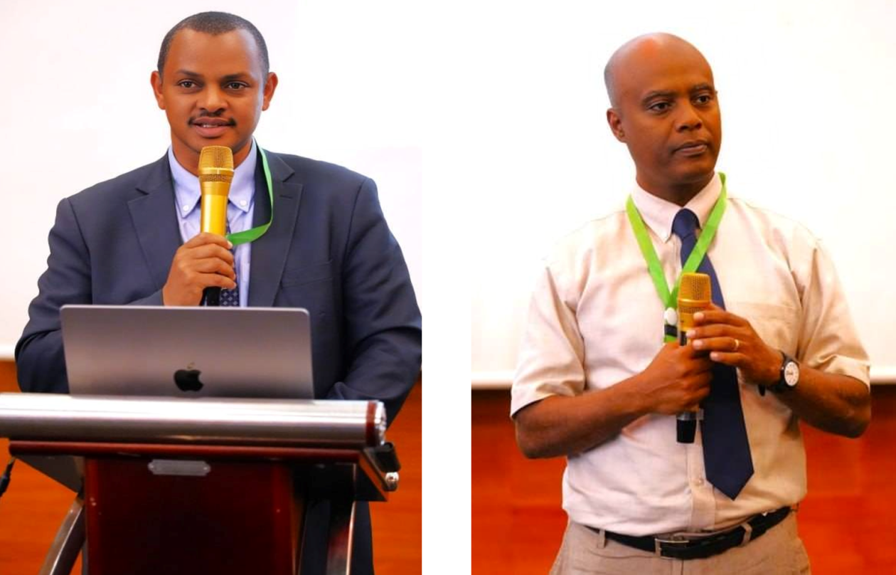 Two speakers holding a microphone