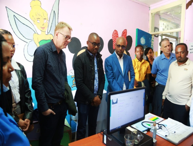 People looking at a piqture on a PC screen