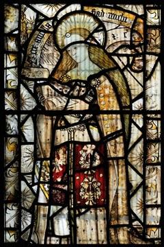 Stained glass picture of a holy woman reading