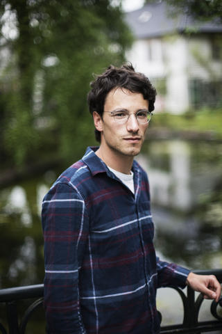 A male student on a bridge in Nygårdsparken