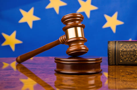 Stock photo of a gavel in front of the EU flag