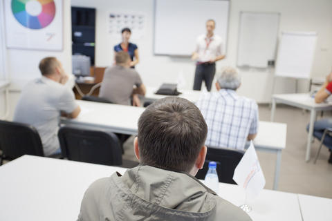 People in a room where a course is taking place