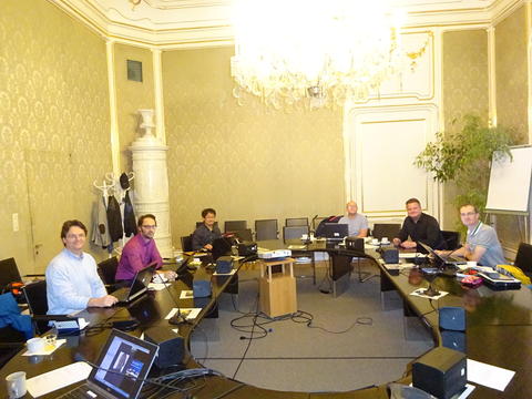 A group of people in a posh meeting room