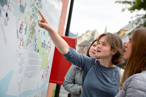 Students looking at a campus map, pointing