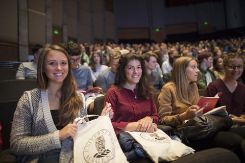 Students sitting in Griegsalen, smiling, attending the Welcome programme
