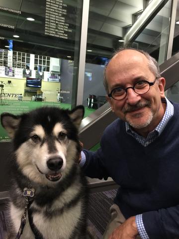 Franklin Furlong at one of The University of Washington (UW) Men's Basketball team's matches. The accompanying husky dog is the school mascot of UW.