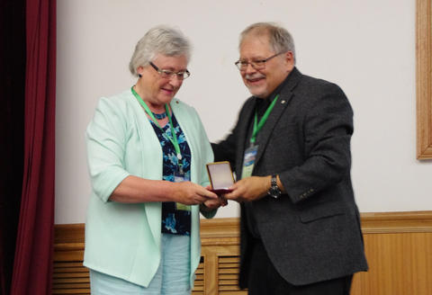 Hilary Birks receiving her Lifetime Achievement medal from John Smol at the International Paleolimnology Symposium