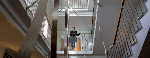 En kvinnelig student står stille i trappeoppgangen i Bjørn Christiansens hus