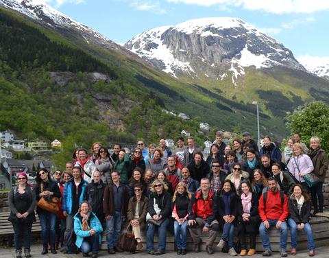 All the participants gathered to get a photo in Odda with snowy mountain in the background.