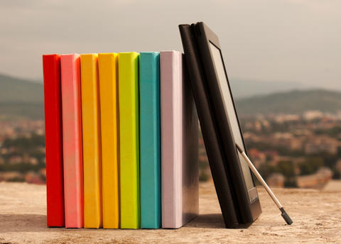 row of books with electronic book reader