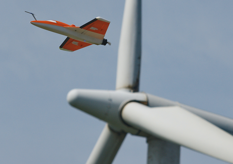 The SUMO unmanned aircraft in front of a wind turbine