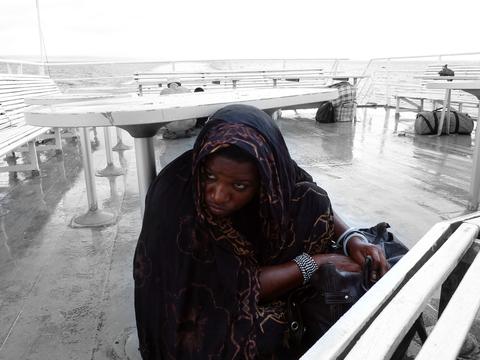 Person on board a ferry between the Tanzanian mainland and the island of Zanzibar in stormy weather.