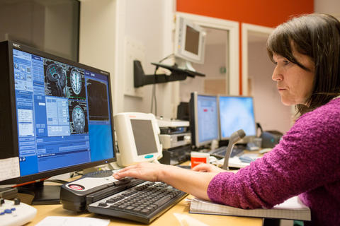 Radiographer Turid Randa records information whilst an Utøya survivor's head is being scanned.