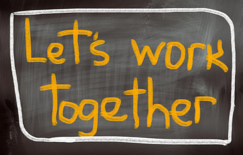 The text 'Let's work together' on a black-board